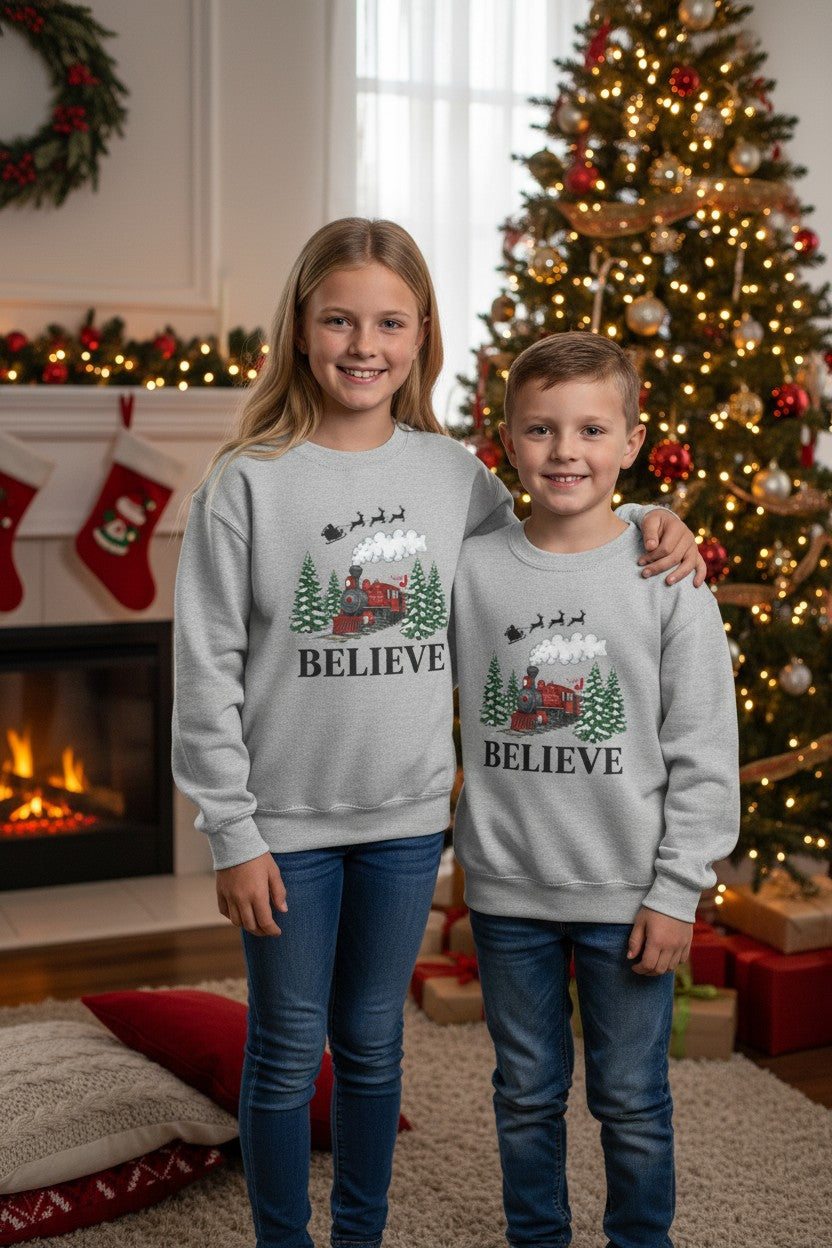Kids Believe Christmas Sweatshirt – Holiday Train & Santa Sleigh Graphic – Girls & Boys Christmas Crewneck – Cozy Winter Outfit for Children