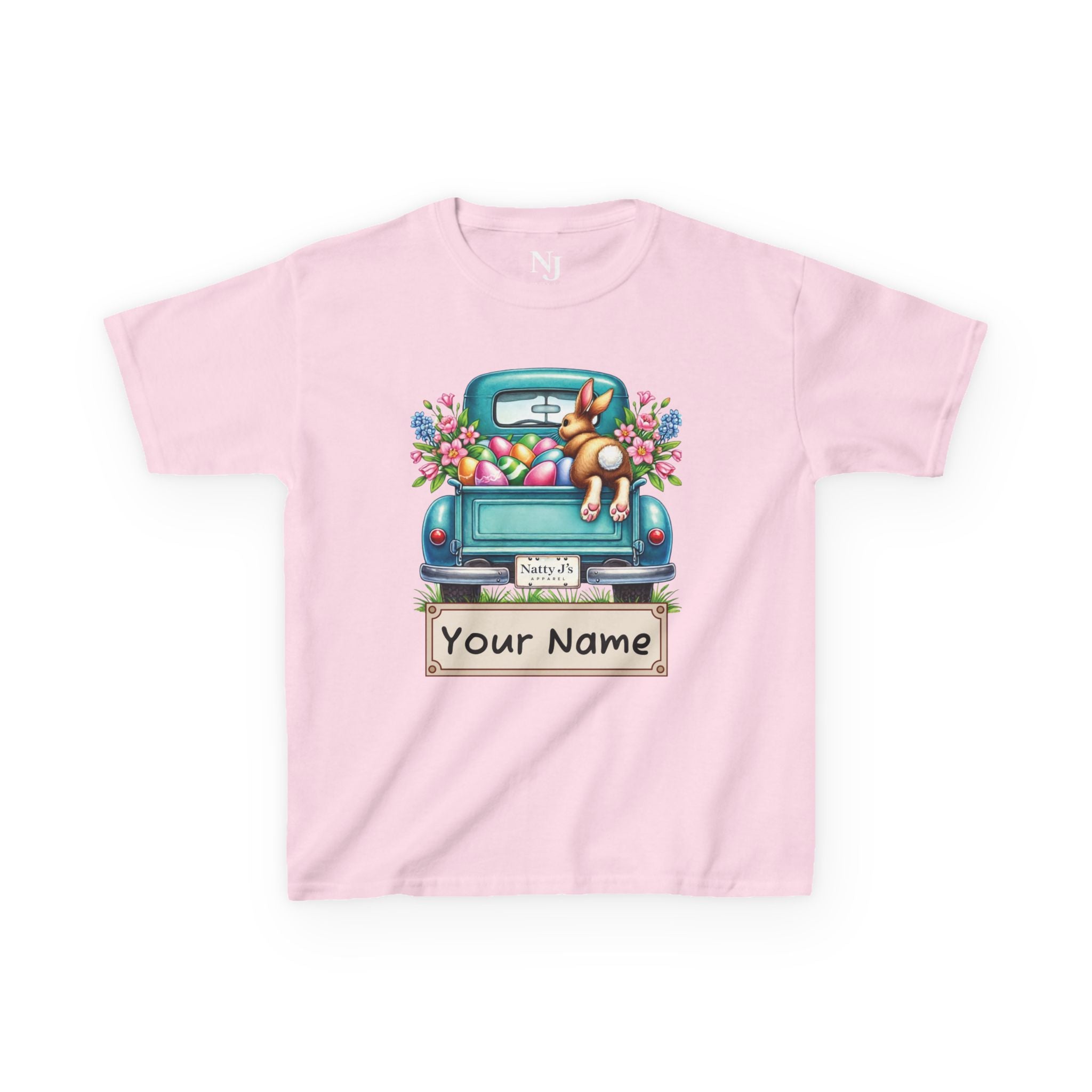 Pink t-shirt with a graphic of a blue truck, dog, and Easter eggs on a white background.