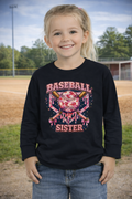 Young girl wearing a black sweatshirt with 'Baseball Sister' design on a baseball field.