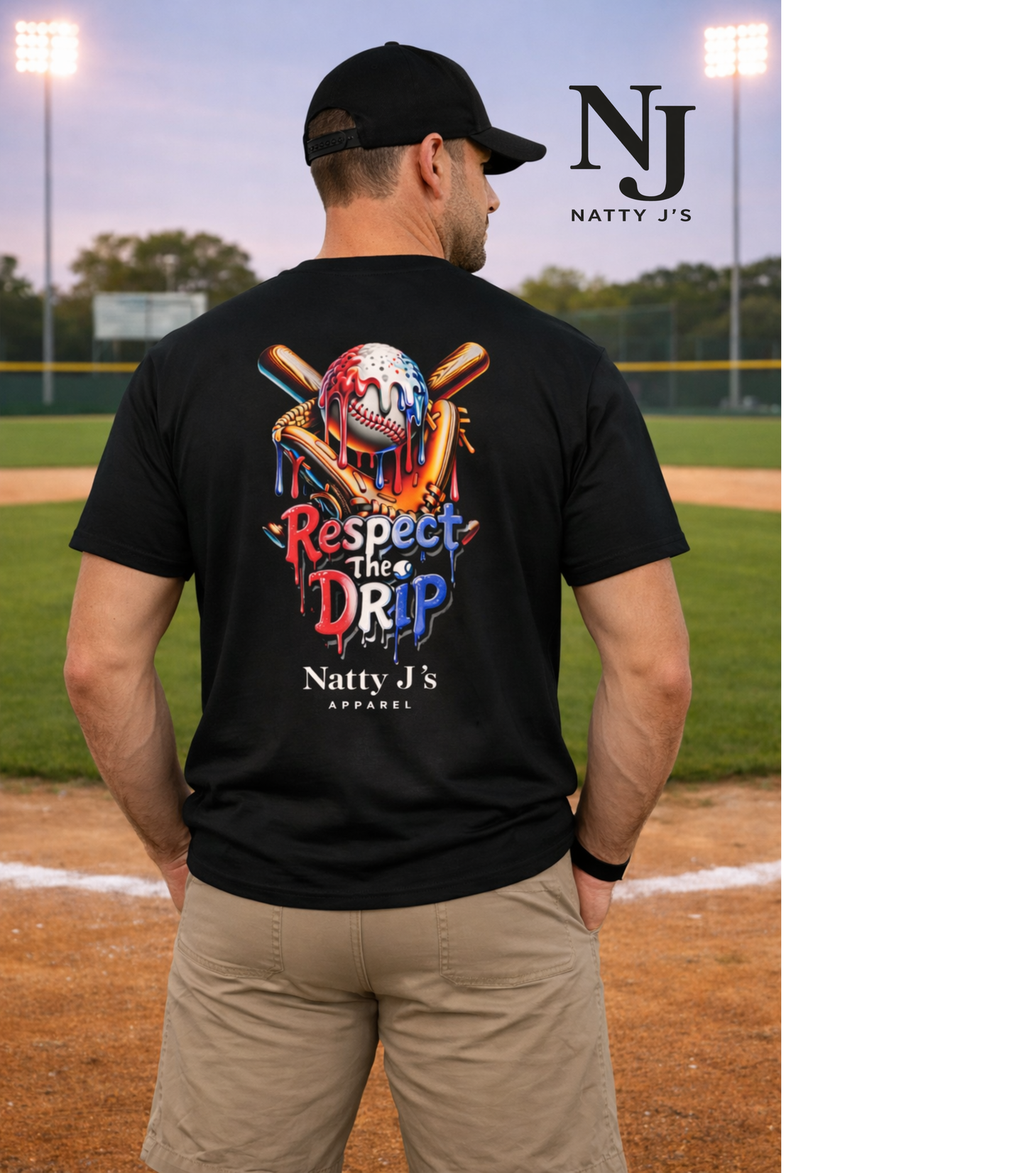 Man wearing a black t-shirt with colorful graphics and text on a baseball field, featuring 'Natty J's' branding.