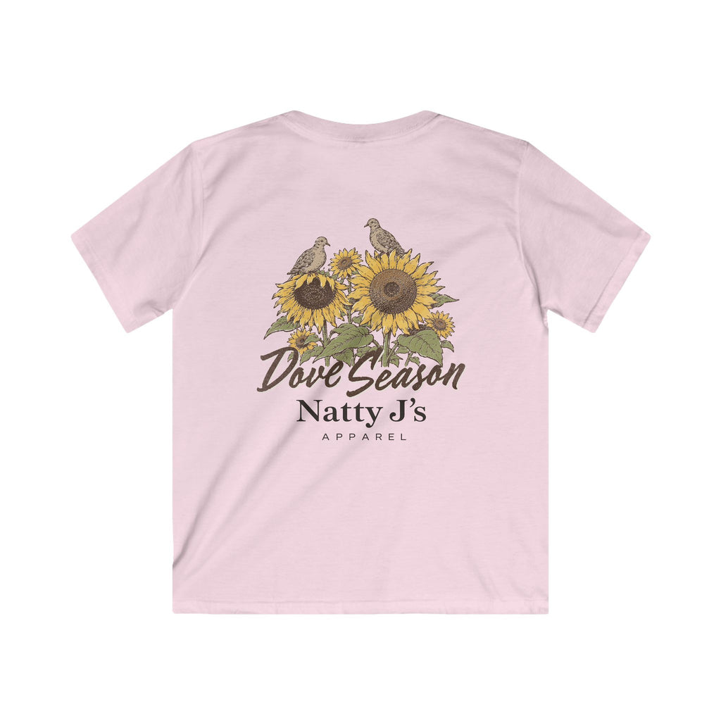 A light pink short-sleeve t-shirt shown from the back, featuring a graphic print of sunflowers, doves, and the text 'Dove Season Natty J's APPAREL'.