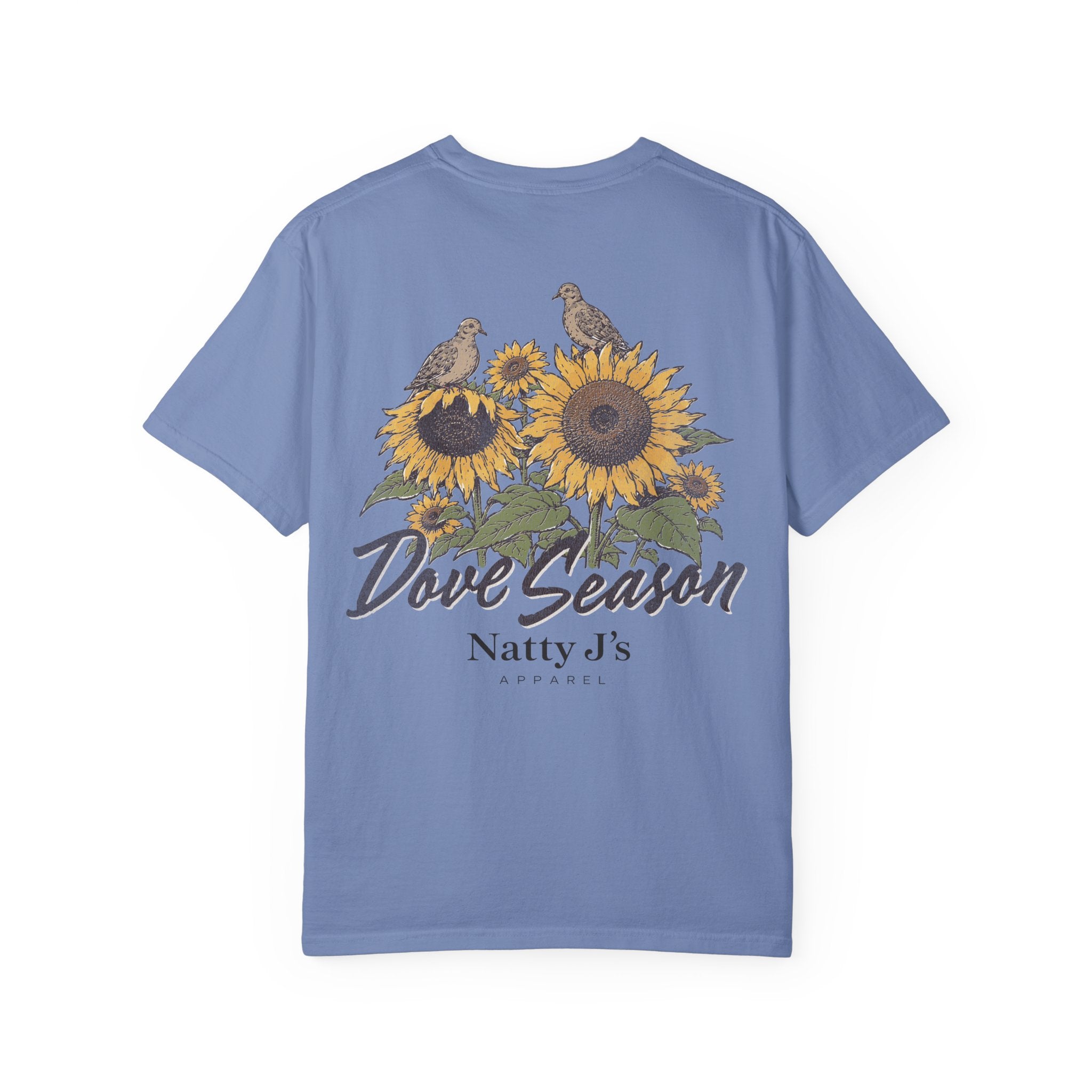 A light blue short-sleeve t-shirt with a graphic on the back featuring two doves perched on sunflowers, with the text 'Dove Season' and 'Natty J's APPAREL' printed below.