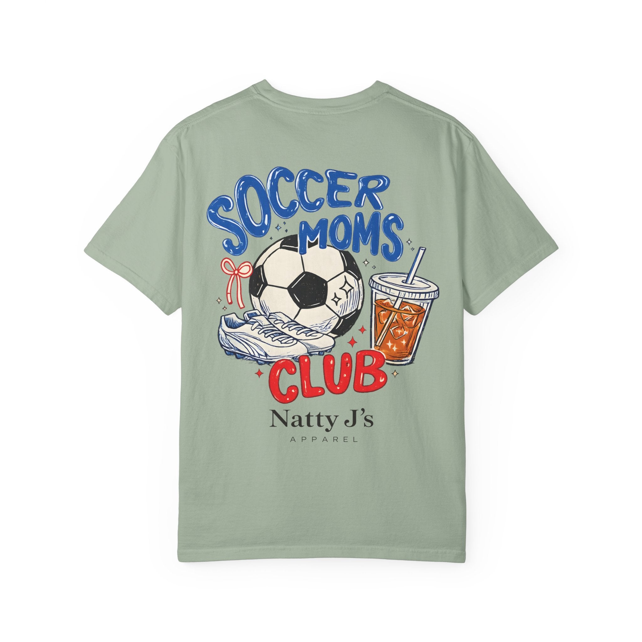 A sage green short-sleeve t-shirt with a colorful graphic on the back featuring a soccer ball, cleats, a drink, and the text 'SOCCER MOMS CLUB' and 'Natty J's APPAREL'.