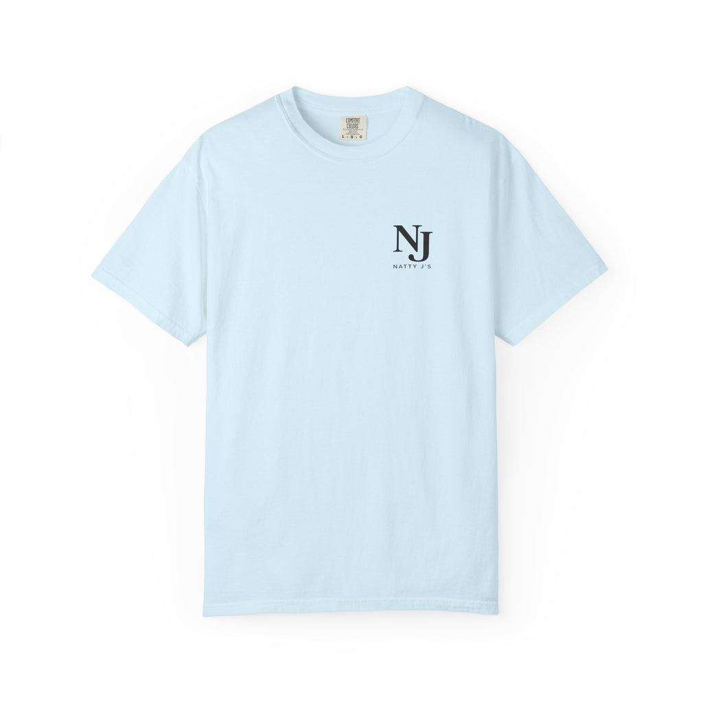 A light blue short-sleeve crewneck t-shirt with a small black cross printed on the left chest, displayed flat against a solid white background.