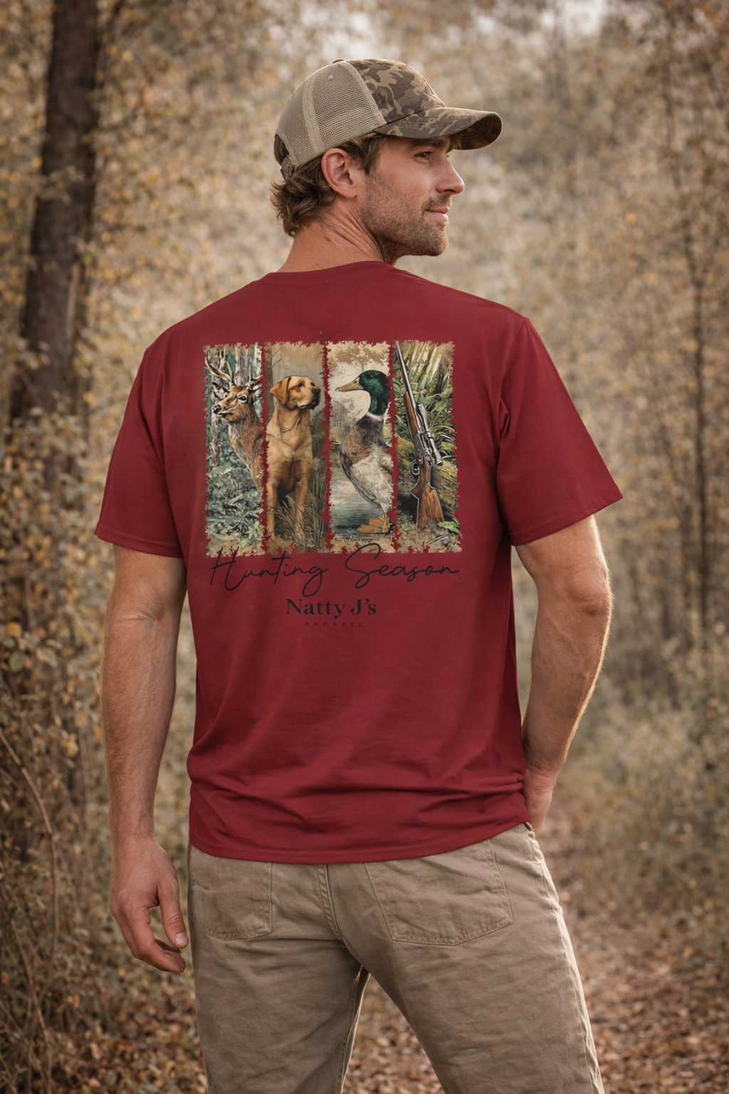 Man wearing a red t-shirt with a hunting graphic and text in a forest setting