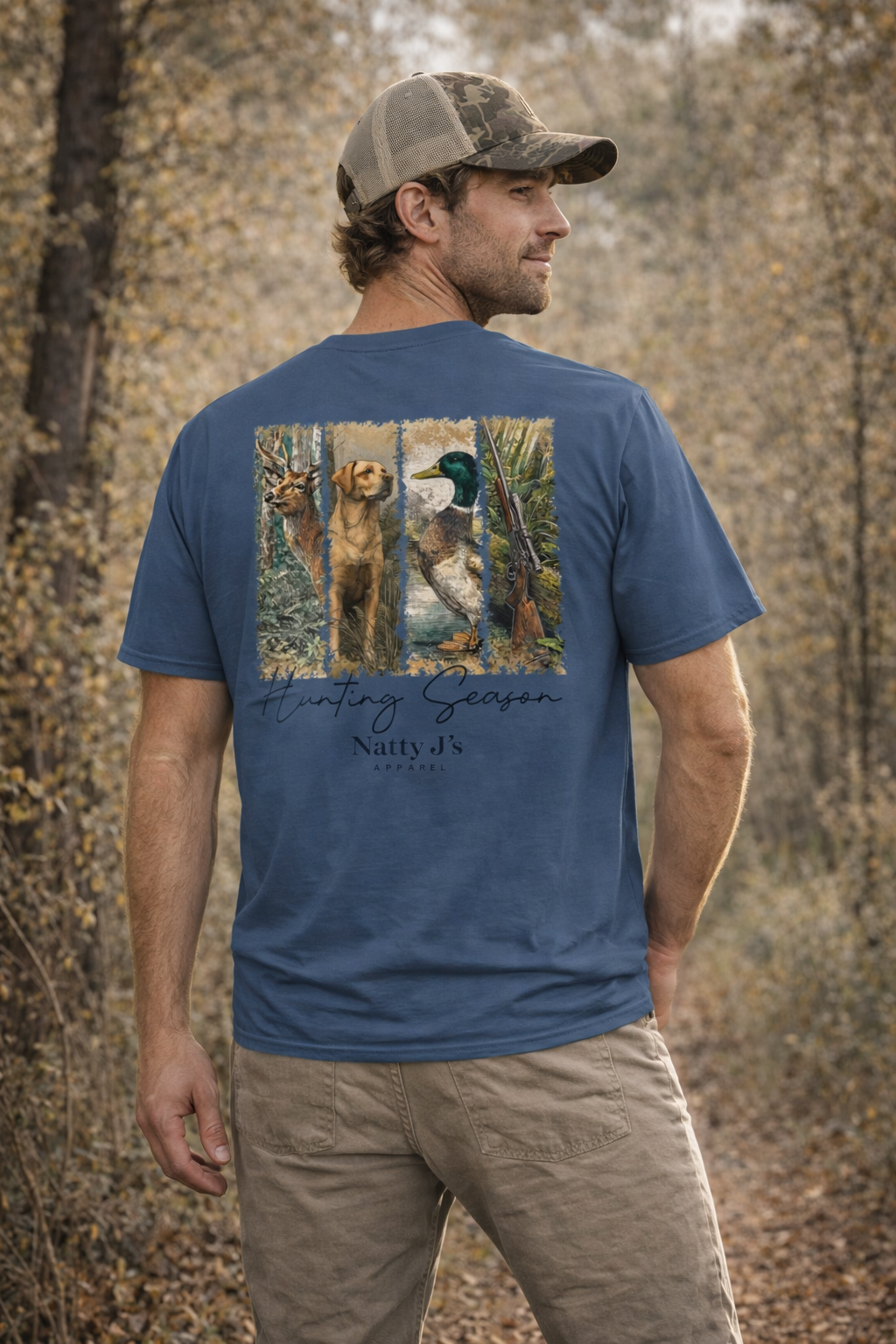 Man wearing a blue t-shirt with hunting scene design outdoors