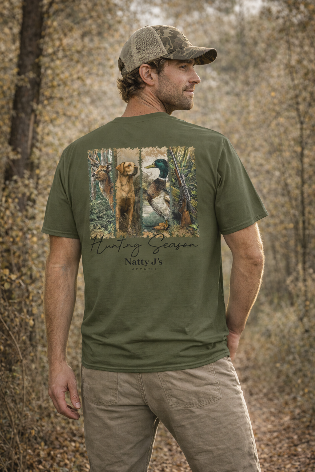 Man wearing a green t-shirt with hunting scene design in a forest setting