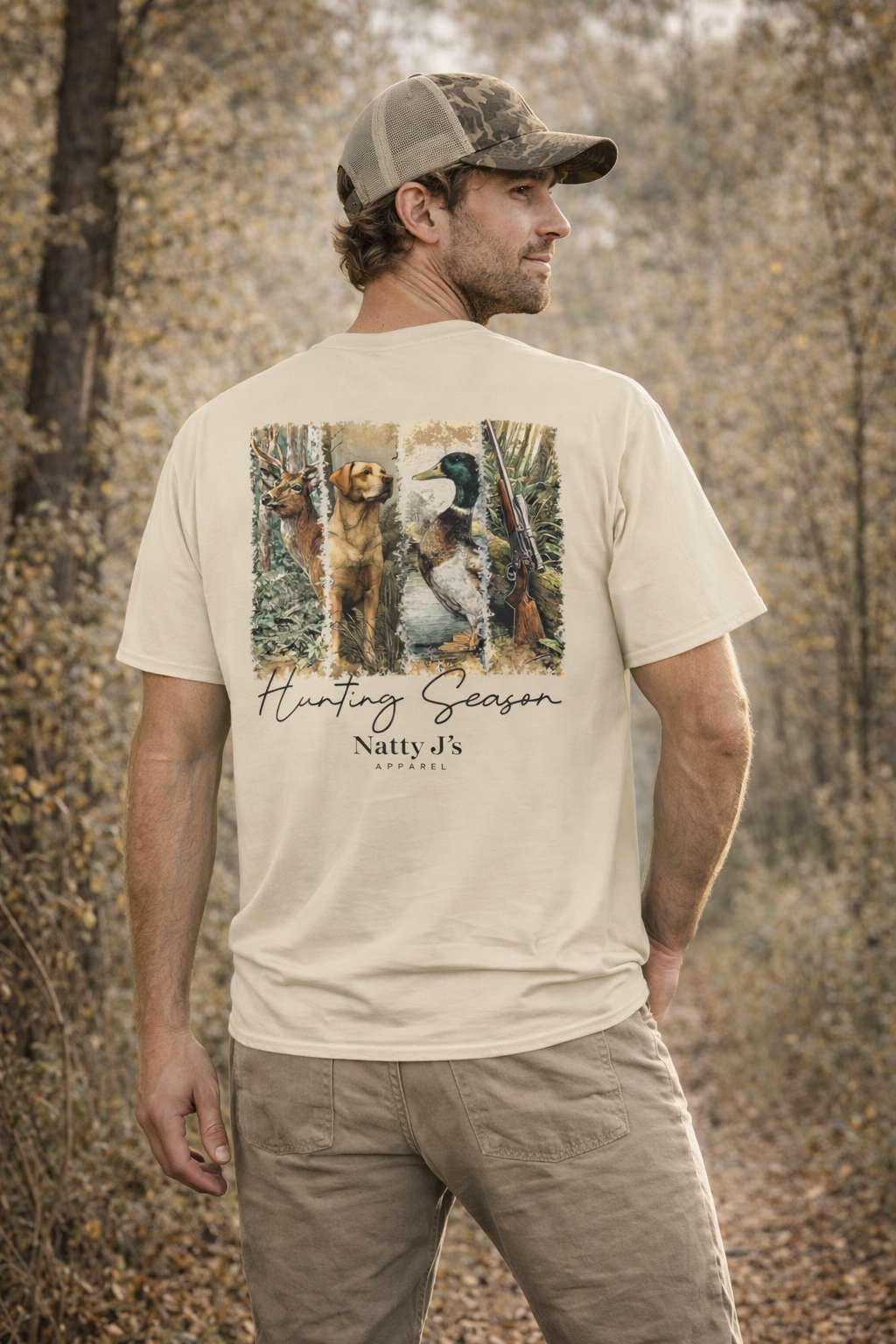 Man wearing a beige t-shirt with hunting-themed design and 'Natty J's' branding outdoors.