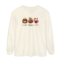 An off-white long-sleeve t-shirt with a graphic of three cozy autumn-themed items: a candle, a pumpkin lantern, and a mug of pumpkin coffee, with the text 'Candles Pumpkin Coffee' printed below.