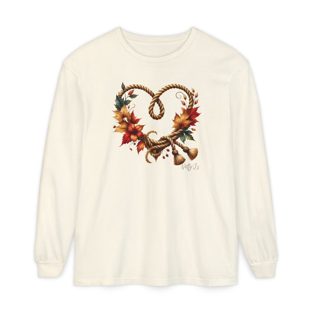 An off-white long-sleeve t-shirt with a graphic of a heart-shaped rope wreath decorated with autumn leaves and small bells, displayed on a clean white background.