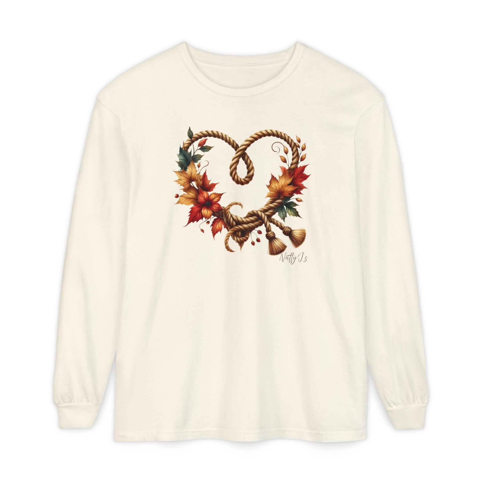 An off-white long-sleeve t-shirt with a graphic of a heart-shaped rope wreath decorated with autumn leaves and small bells, displayed on a clean white background.