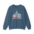 A slate blue crewneck sweatshirt featuring a colorful Christmas village graphic on the chest with a decorated tree, candy cane houses, and the text 'CANDY CANE LANE'.