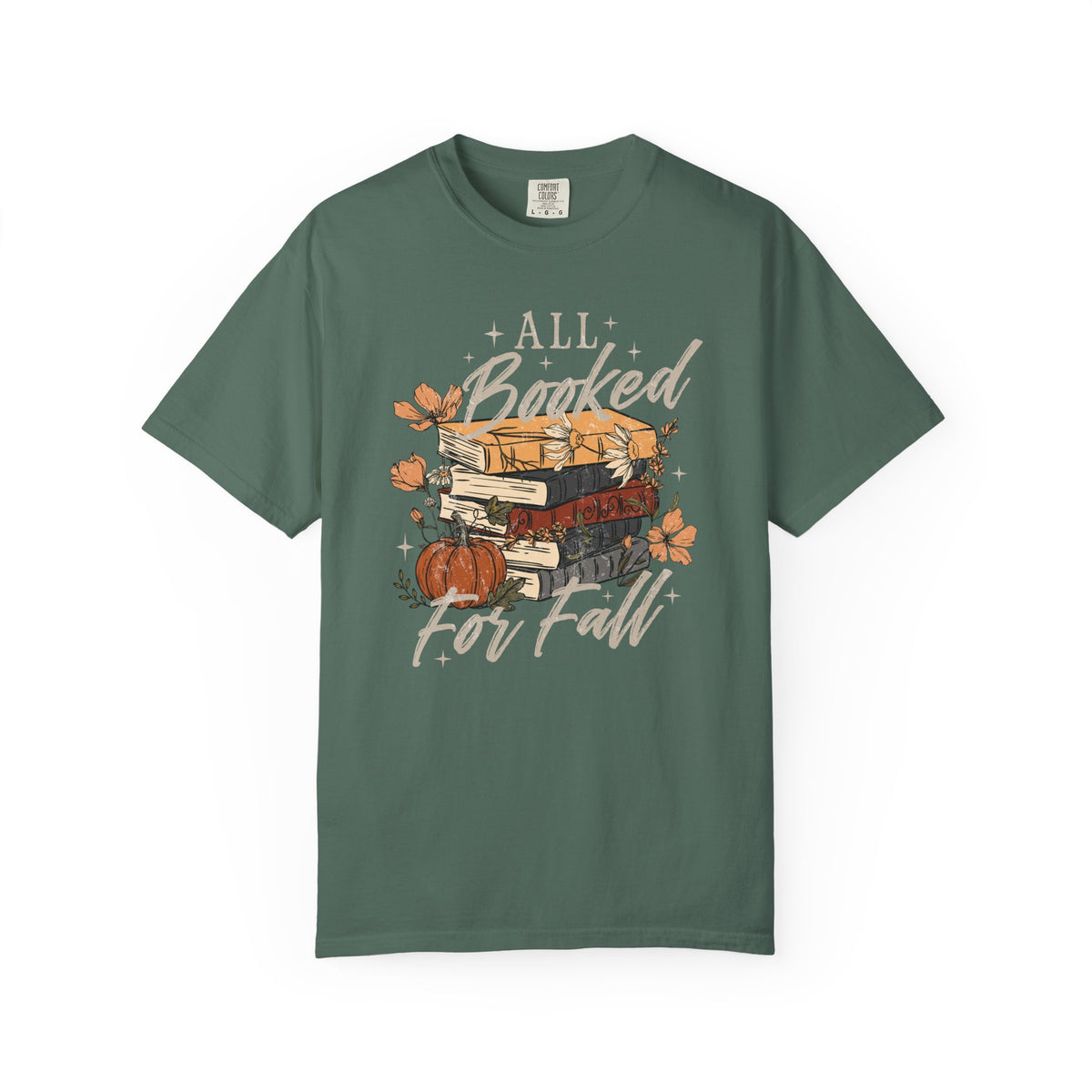 A dark green crewneck t-shirt featuring a graphic of a stack of books, a small pumpkin, and autumn leaves with the text 'ALL Booked For Fall' in a stylized font, displayed on a clean white background.